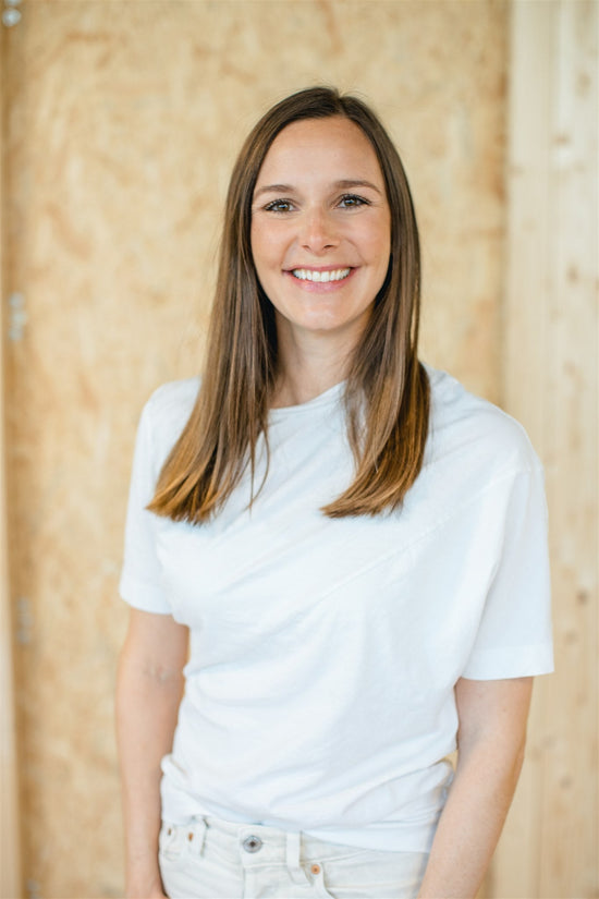 Anna Mucha, founder and COO and CPO of OiOiOi - woman with light brown hair and white clothes standing 