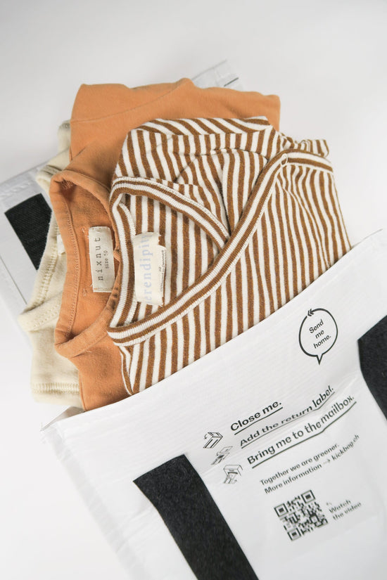 Organic baby clothes from OiOiOi in brown and white striped in a recyclable package